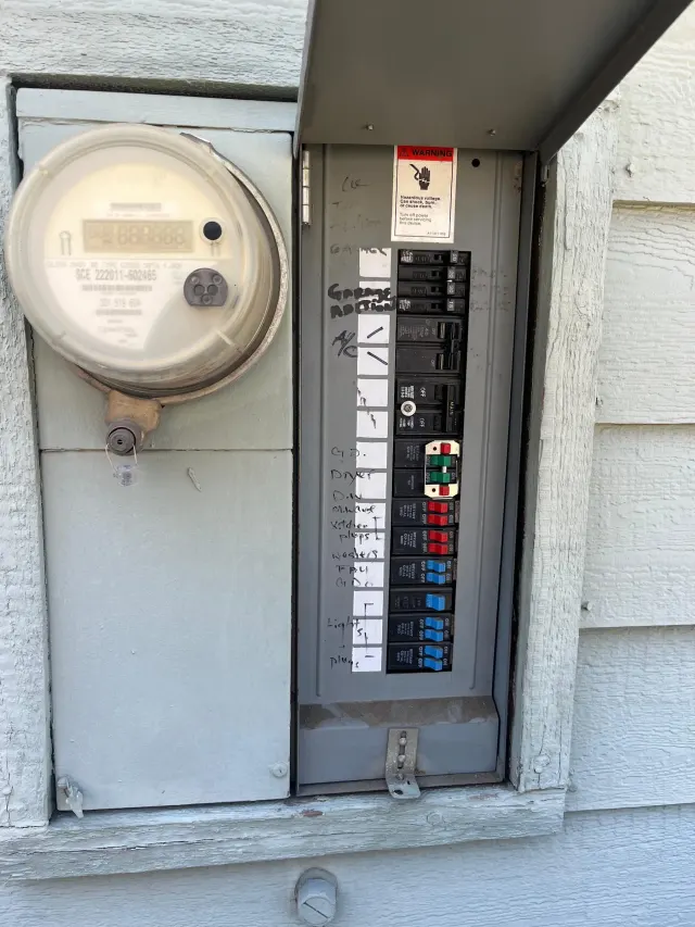 Electrical in Rancho Cucamonga: the electric meter and the breaker panel on the outside wall of the home