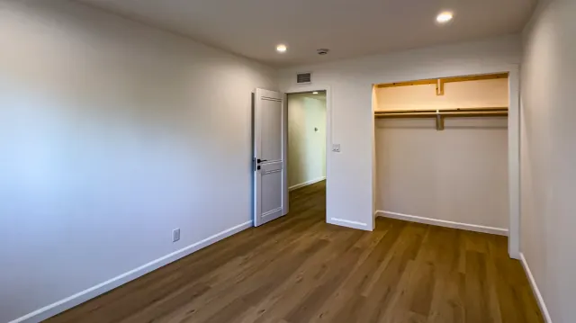 Full remodel in Thousand Oaks: bedroom with an air register high on the wall above the door, and recessed lights
