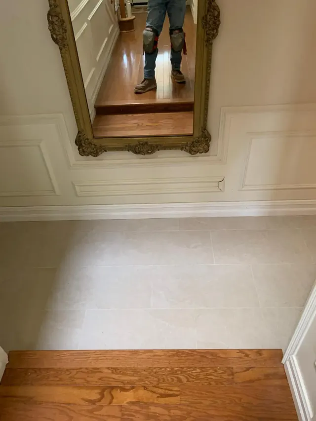 Kitchen remodel in Claremont: new floor tile meeting the wood floor at the step