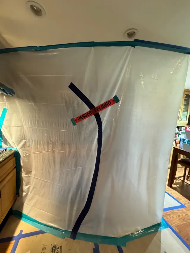 Mold remediation in Santa Clarita: plastic containment taped off around the work area before anything is removed