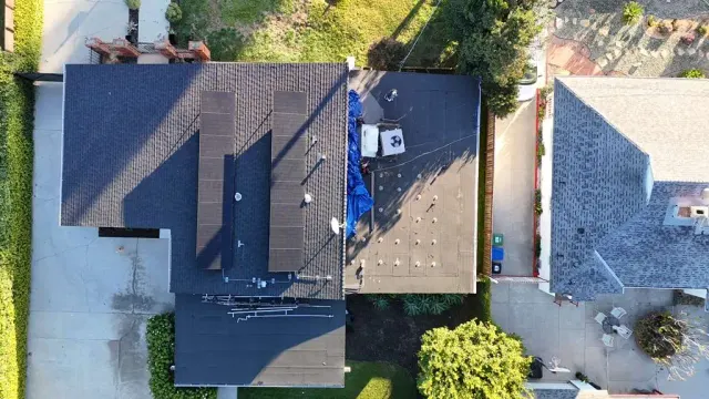 Van Nuys job with mold remediation, roofing and HVAC work: the roof from above, with the rooftop HVAC unit beside the solar panels