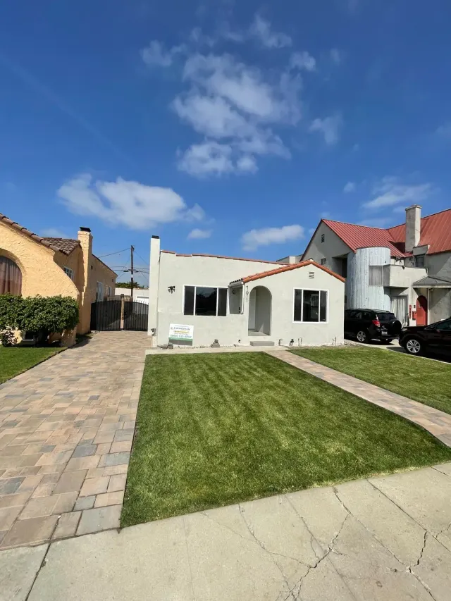 Front yard in Los Angeles with a paver driveway, a paver walkway and a new lawn