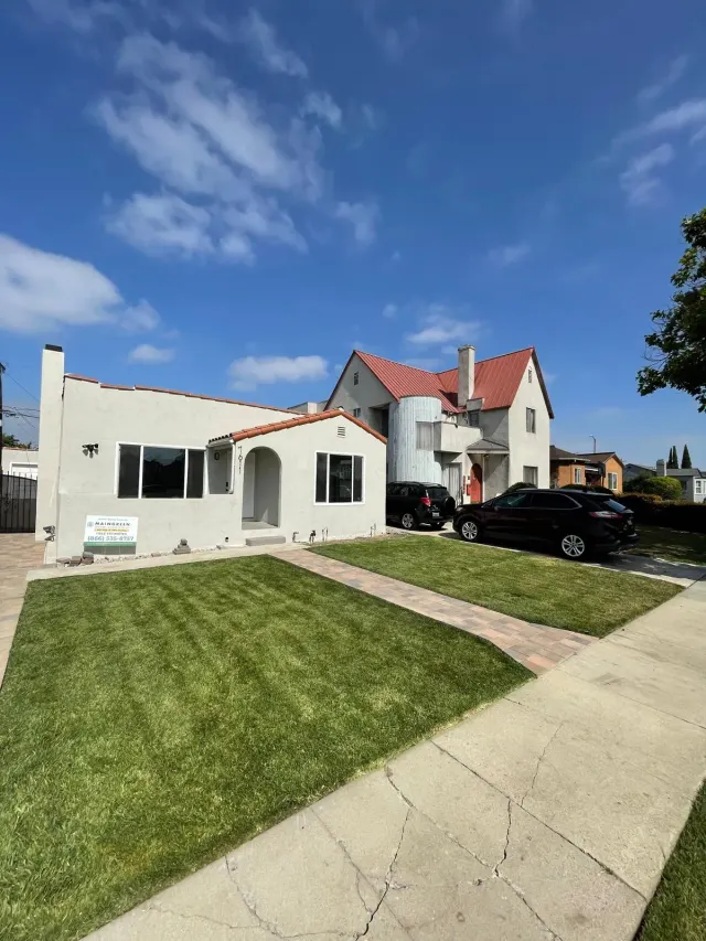 Paver walkway to the front door of a Los Angeles home, between two new lawns