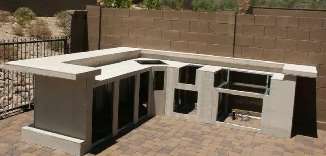 Outdoor kitchen frame on a paver patio, with openings left for the grill and appliances