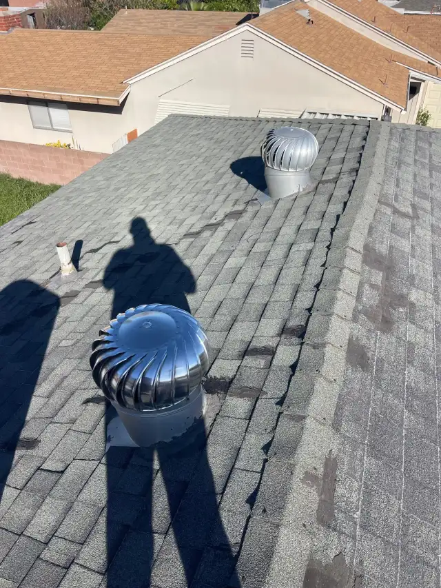 Roofing in Fontana: two turbine attic vents on the shingle roof