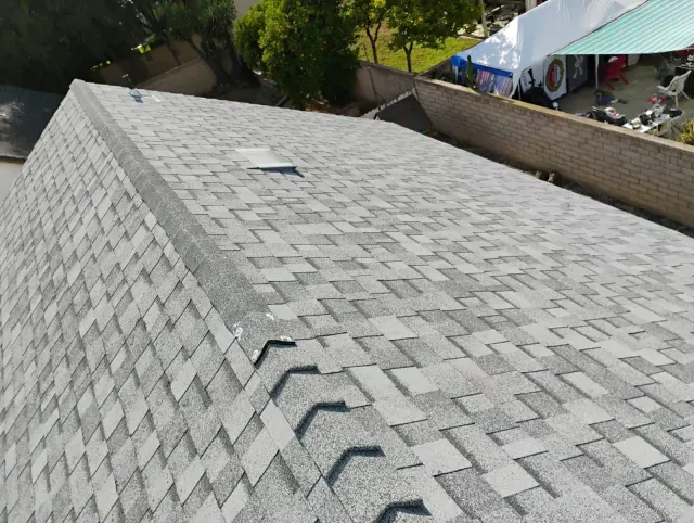 Roofing in Simi Valley: gray shingle roof with an attic vent below the ridge
