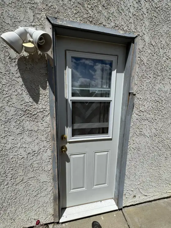 Simi Valley home where we did roofing, windows and doors: a half-glass exterior door in the stucco wall