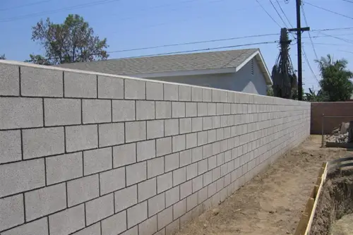 Long concrete block wall along a side yard